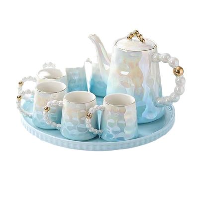 Tazas de café y platillos de cerámica de diseño de perla rosa en forma de concha para los amantes del té