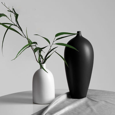 Decoración de la mesa de un jarrón cerámico blanco y negro moderno para la ocasión del aniversario